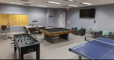 a room with a ping pong table and a tv at Deluxe 1 Bedroom Apartment • Brickell • Ocean View in Miami
