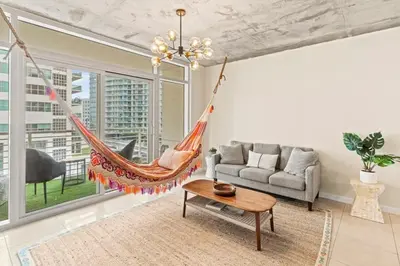 a hammock in a living room with a couch at Urban Retreat - Location Pool Gym & Parking in Miami