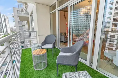 a balcony with two chairs and a table on a building at Urban Retreat - Location Pool Gym & Parking in Miami