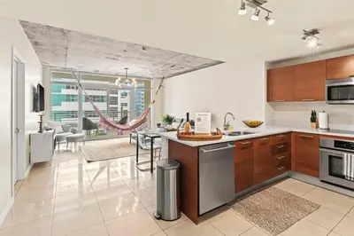 a kitchen and living room with a counter top at Urban Retreat - Location Pool Gym & Parking in Miami