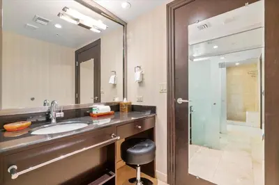 a bathroom with a sink and a mirror and a shower at Penthouse Bahia Mar South Beach on Ocean Drive Miami Beach home in Miami Beach