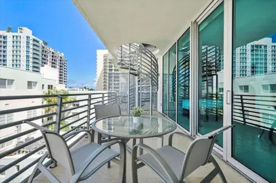 a balcony with a glass table and chairs at Penthouse Bahia Mar South Beach on Ocean Drive Miami Beach home in Miami Beach