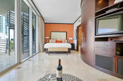 a bedroom with a bed and a bottle of wine at Penthouse Bahia Mar South Beach on Ocean Drive Miami Beach home in Miami Beach