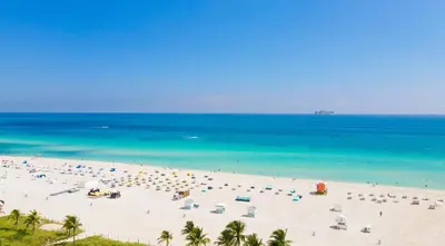 a beach with a lot of umbrellas and the ocean at Penthouse Bahia Mar South Beach on Ocean Drive Miami Beach home in Miami Beach