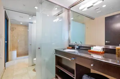 a bathroom with a sink and a toilet and a mirror at Penthouse Bahia Mar South Beach on Ocean Drive Miami Beach home in Miami Beach
