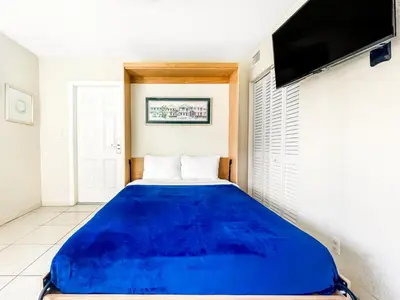 a large blue bed in a room with a tv at The Starfish in Hollywood