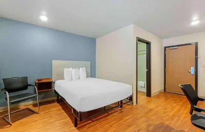 a bedroom with a bed and a desk and a chair at Extended Stay America Select Suites - Fort Lauderdale - Airport - West in Davie