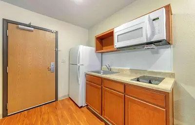 a kitchen with a white refrigerator and a microwave at Extended Stay America Select Suites - Fort Lauderdale - Airport - West in Davie