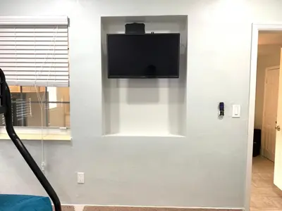 a flat screen tv hanging on a wall at Private Hollywood APT Near Beach Airport & Casino in Hollywood