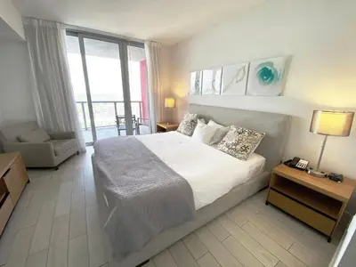 a bedroom with a large bed and a large window at Beachfront Apartment in Miami Beach with Stunning Views 1A in Hallandale Beach