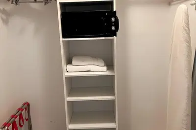 a white closet with a towel and a microwave at Beachfront Apartment in Miami Beach with Stunning Views 1A in Hallandale Beach