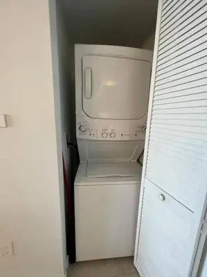 a white microwave sitting on top of a refrigerator at Beachfront Apartment in Miami Beach with Stunning Views 1A in Hallandale Beach