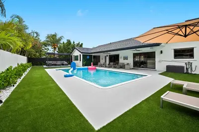 a swimming pool in the backyard of a house at Villa Paradise Miami, Luxury Gem with Heated Pool, Game Room, Fire Pit, 3 Bed 2 Bath in Miami