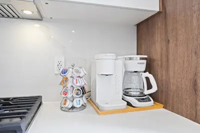 a kitchen counter with a coffee maker on a shelf at Villa Paradise Miami, Luxury Gem with Heated Pool, Game Room, Fire Pit, 3 Bed 2 Bath in Miami