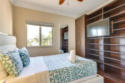a bedroom with a bed and a flat screen tv at Spacious Miami Retreat with Grill, Pool and Dock! in Miami