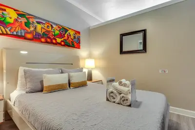 a bedroom with a bed and a painting on the wall at Sunny Miami Beach Condo Steps to Boardwalk! in Miami Beach