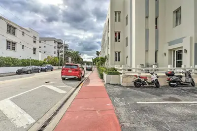 a red van parked on the side of a street at Sunny Miami Beach Condo Steps to Boardwalk! in Miami Beach