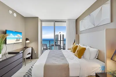 a bedroom with a large bed and a view of the ocean at Oceanfront Balcony - Endless Views - Amazing Pools in Hollywood