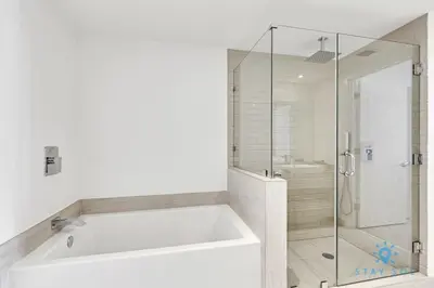 a white bathroom with a tub and a shower at Oceanfront Balcony - Endless Views - Amazing Pools in Hollywood