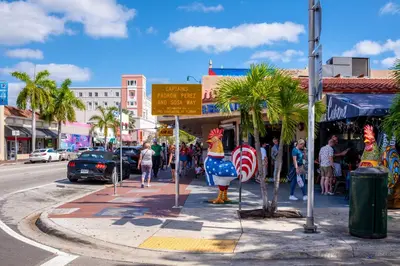 a group of people walking down a street next to a sidewalk at Chic 2BR Little Havana Apt with Free Parking in Miami
