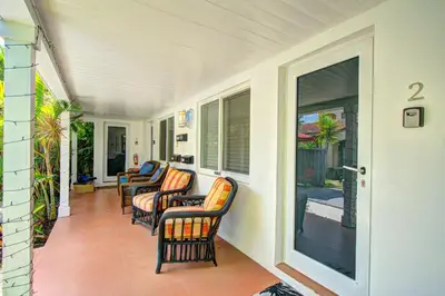 a porch with chairs and windows on a house at Efficiency 3 on water Las Olas beach and free kayaks in Fort Lauderdale