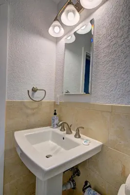 a bathroom with a white sink and a mirror at Efficiency 3 on water Las Olas beach and free kayaks in Fort Lauderdale