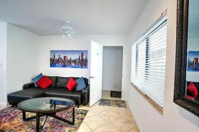 a living room with a black couch and a glass table at A 1bedroom Las Olas on the water in Fort Lauderdale