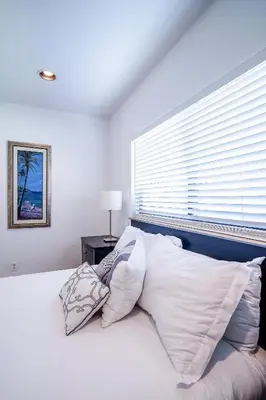a bedroom with a bed with white pillows and a window at A 1bedroom Las Olas on the water in Fort Lauderdale