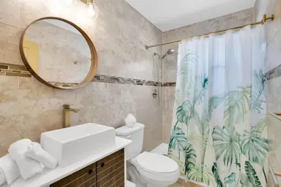 a bathroom with a toilet and a shower curtain at LoKal Rental Tropical Florida destination in Fort Lauderdale