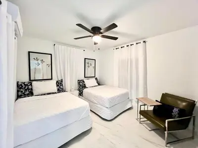 a bedroom with two beds and a ceiling fan at 3 Seasons at the Carrington 3 Two Bedroom 1 Bath Apts -6 Bedrooms 3 bathrooms and 3 bedroom 2 bathroom Villa in Miami