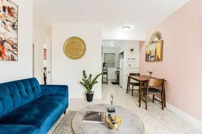 a living room with a blue couch and a table at Full 1BR Apt Close Downtown with Free Parking in Miami