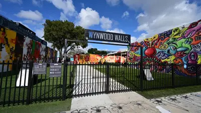a gate with a fence with graffiti on it at Bright and Airy Miami 1BR Apt Near Brickell in Miami