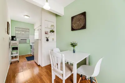 a dining room with a white table and chairs at 1BR Little Havana Apt stepts to Calle 8 in Miami