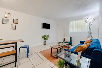 a living room with a blue couch and a table at Trendy 2BR Little Havana Apartment in Miami