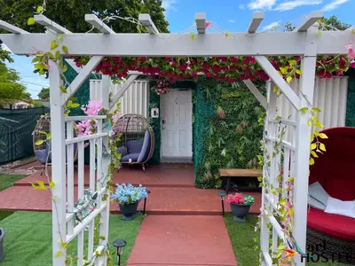 a white pergola with flowers on it at Summer Gardens in Miami
