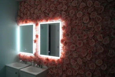 a bathroom with two sinks and a mirror with red lights at Summer Gardens in Miami