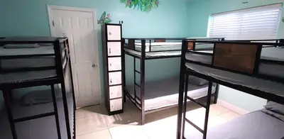 a room with three bunk beds in a room at Summer Gardens in Miami
