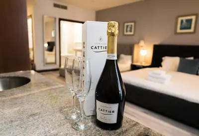 a bottle of wine and two glasses on a counter at Rooftop-Pool Suite with King Bed in Ocean Dr C303 in Miami Beach