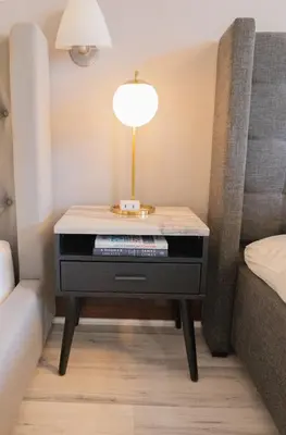 a table in a bedroom with a bed and a lamp at Rooftop-Pool Suite with King Bed in Ocean Dr C303 in Miami Beach