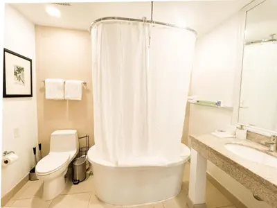a white bathroom with a toilet and a sink at Rooftop-Pool Suite with King Bed in Ocean Dr C303 in Miami Beach