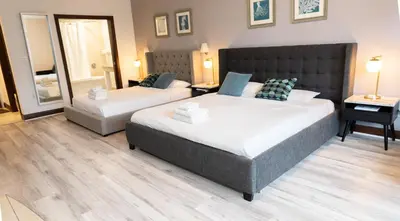 a bedroom with two beds and a mirror at Rooftop-Pool Suite with King Bed in Ocean Dr C303 in Miami Beach
