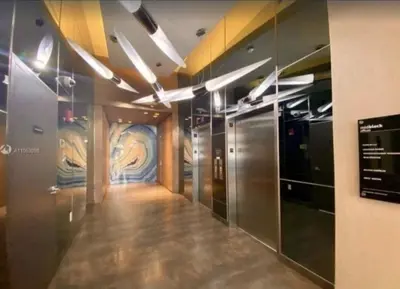 a hallway in a building with a painting on the wall at Beautiful 1BD 1BTH at Midblock FREE PARKING in Miami