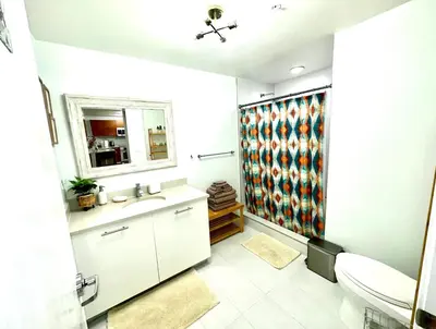 a bathroom with a sink and a toilet and a mirror at Beautiful 1BD 1BTH at Midblock FREE PARKING in Miami