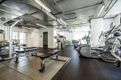 a gym with several treadmills and cardio machines at Beautiful 1BD 1BTH at Midblock FREE PARKING in Miami