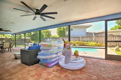 a patio with a stack of plates and a toy unicorn at Wilton Manors Home with Pool about 4 Mi to Beach! in Fort Lauderdale