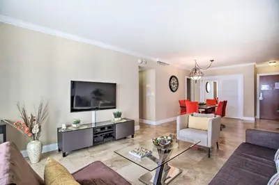a living room with a couch and a tv at Ocean-View Balcony Beachfront Hollywood Apt! in Hollywood