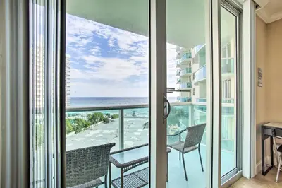 a room with a balcony with a view of the ocean at Ocean-View Balcony Beachfront Hollywood Apt! in Hollywood
