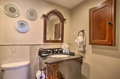 a bathroom with a sink and a toilet and a mirror at Ocean-View Balcony Beachfront Hollywood Apt! in Hollywood