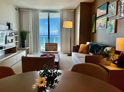 a living room with a couch and a table at Modern Beachfront Condo with Stunning Ocean View in Hollywood