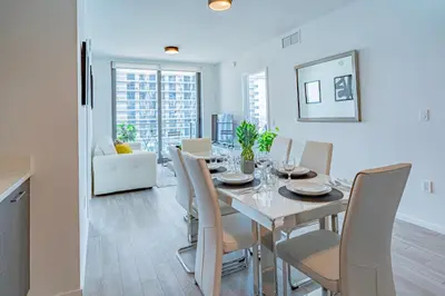 a dining room and living room with a table and chairs at Luxurious 2-Bed Apartment with Breathtaking Bay views!! in Miami
